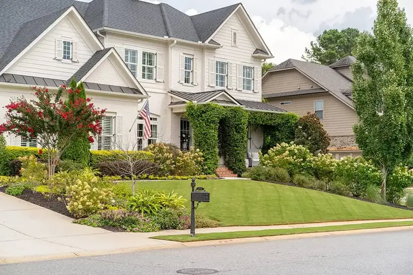 Front-yard curb appeal with layered beds and a manicured lawn
